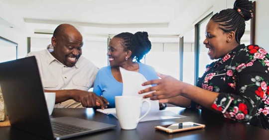 Man and woman working with attorney to draft will or trust