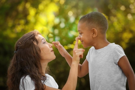 Mother touching sons nose