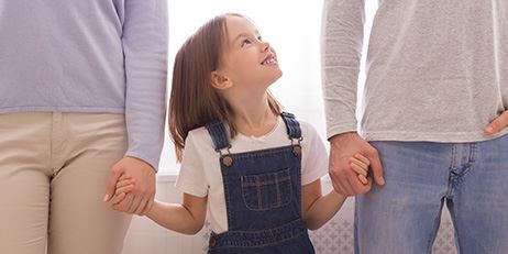 child holding parents hands