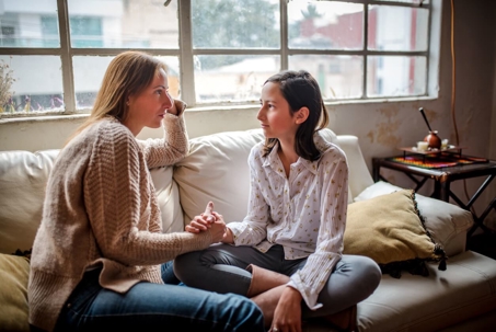 Mom and daughter talking on couch
