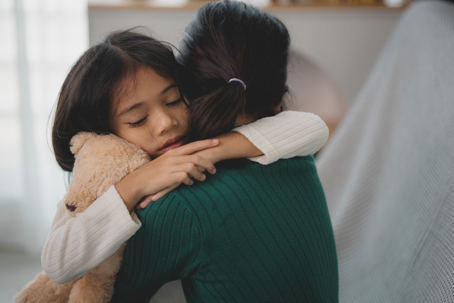 mother hugging daughter