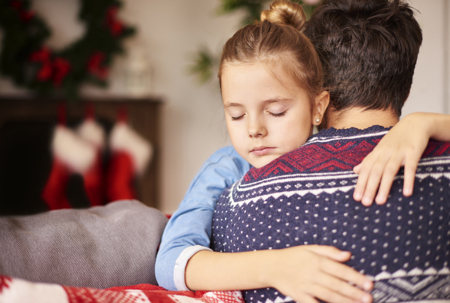 father comforting daughter during the holidays