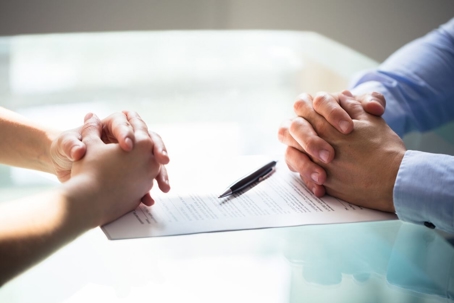 Two people signing divorce papers
