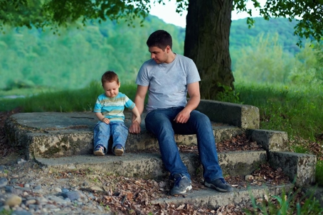 Father looking down at young child